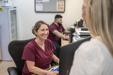 Patient service representative smiles at patient